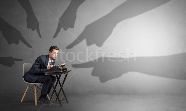 Shadow hands pointing at a small worker Stock photo © ra2studio