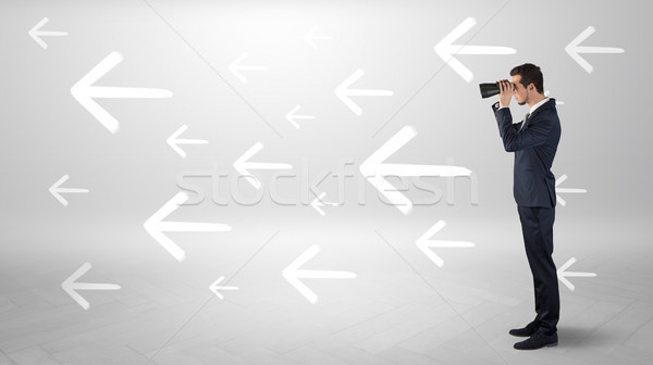 Man looking with binoculars and arrows around Stock photo © ra2studio