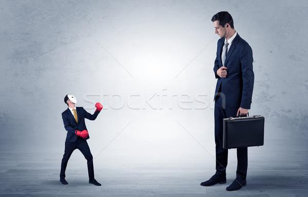 Businessman begging for small masked businessman Stock photo © ra2studio