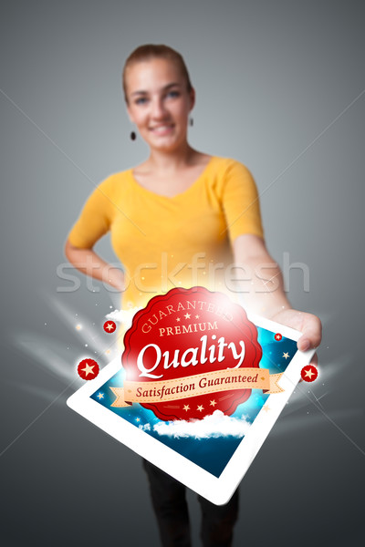 woman holding tablet with red quality label in clouds Stock photo © ra2studio