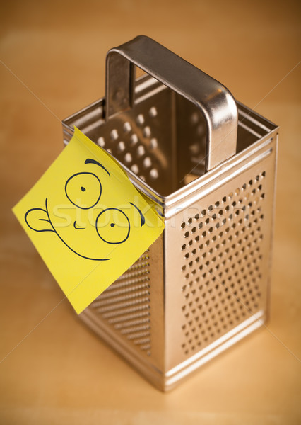 Post-it note with smiley face sticked on a grater Stock photo © ra2studio
