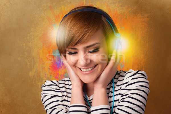 Young woman with headphones listening to music Stock photo © ra2studio