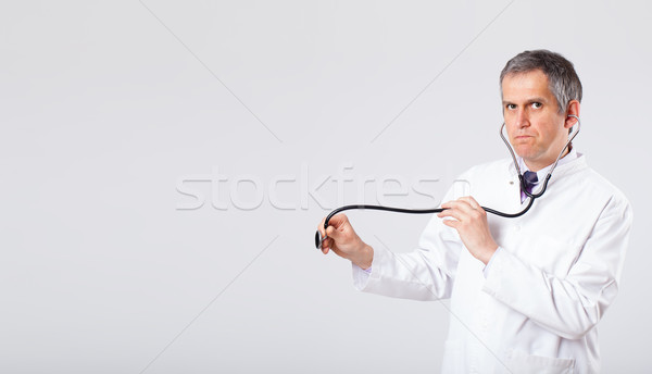 Doctor listening to empty copy space with stethoscope Stock photo © ra2studio