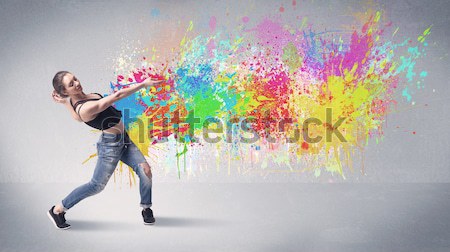 Hipster guy shouting colorful paint on wall Stock photo © ra2studio