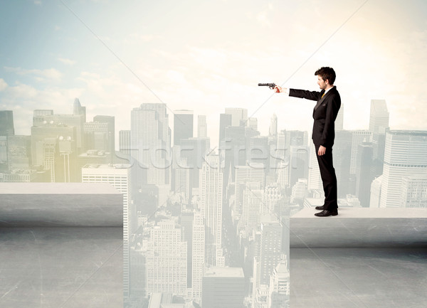 Businessman standing on the edge of rooftop Stock photo © ra2studio