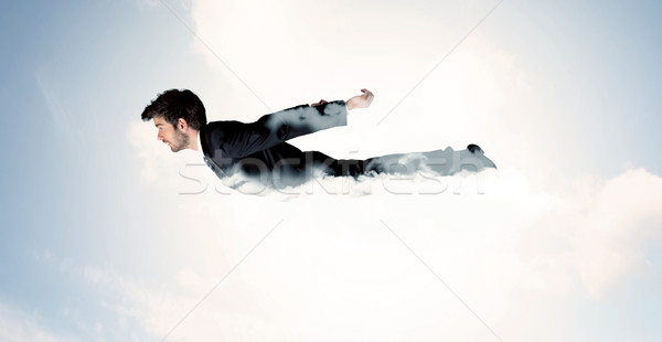 Stock photo: Business man flying like a superhero in clouds on the sky