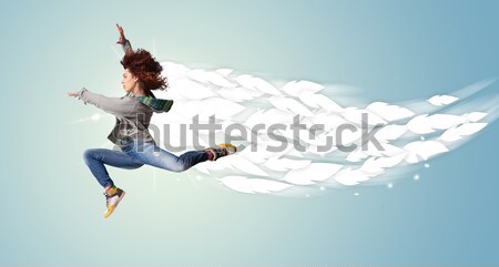 Stock photo: Beautiful woman jumping with colorful gems and crystals on the b