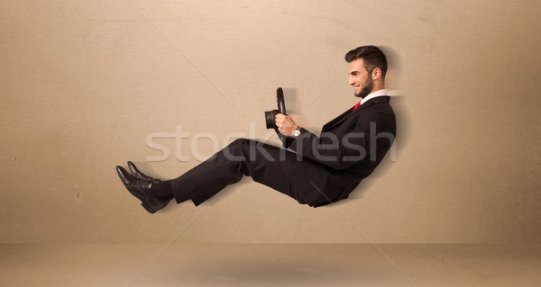 Happy funny man driving a flying car concept Stock photo © ra2studio