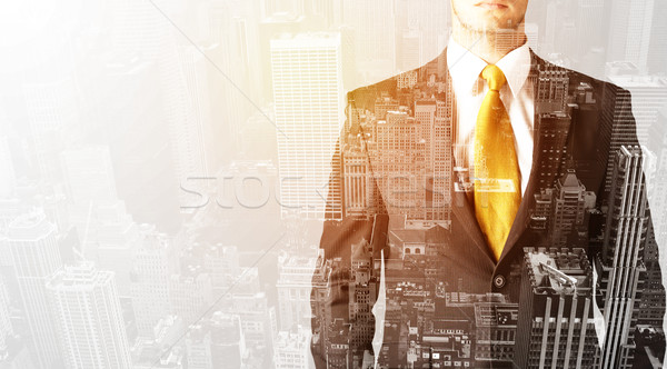 Business person with warm color overlay of city background Stock photo © ra2studio