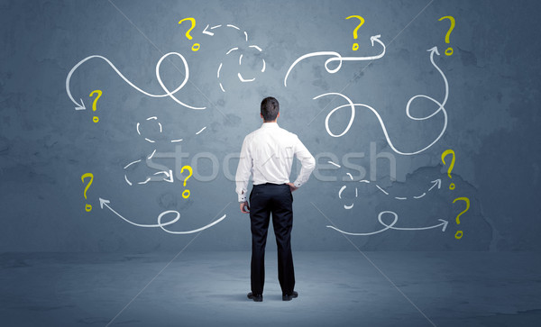 Unsure businessman with question marks Stock photo © ra2studio