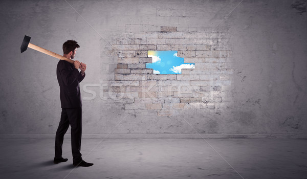 Business man hitting brick wall with hammer Stock photo © ra2studio