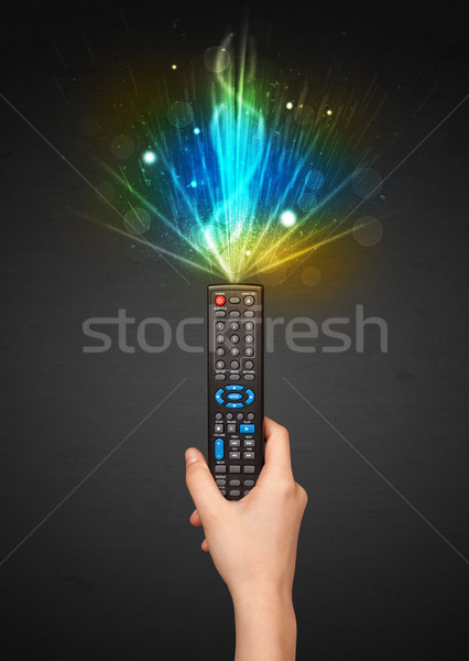 Hand with remote control and explosive signal Stock photo © ra2studio