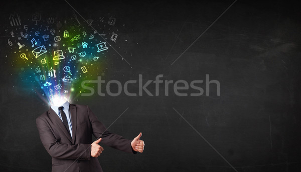 Business man with glowing media icons exploding head  Stock photo © ra2studio