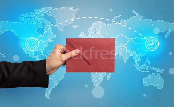 Hand holding envelope with global concept Stock photo © ra2studio