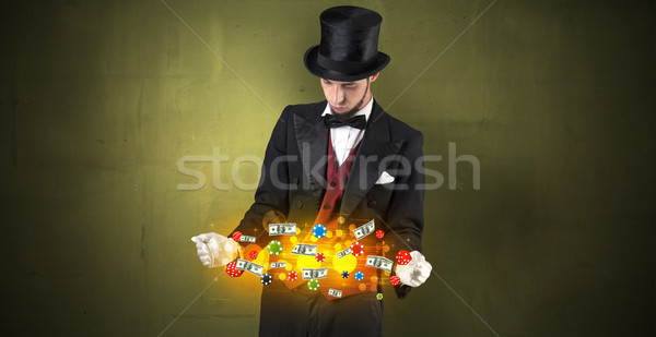 Illusionist conjure with his hand gambling staffs Stock photo © ra2studio