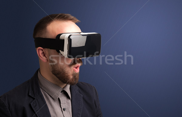 Businessman with virtual reality goggles Stock photo © ra2studio