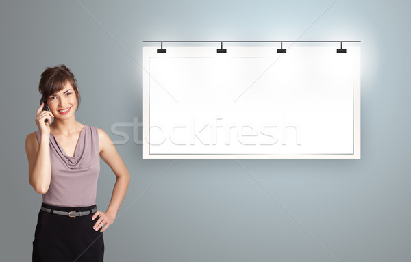 beautiful young woman standing next to a modern copy space and making phone call Stock photo © ra2studio