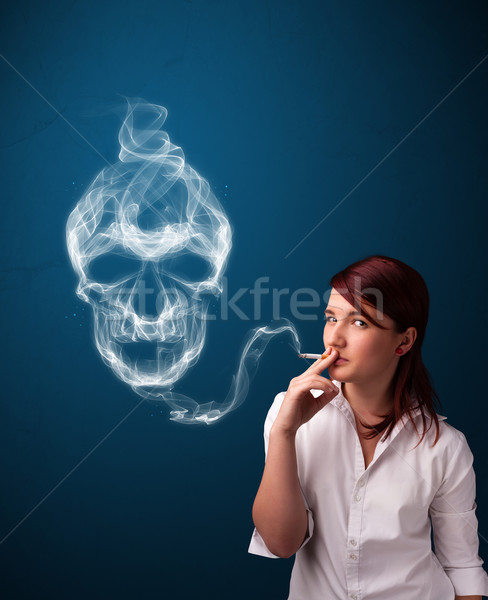 Young woman smoking dangerous cigarette with toxic skull smoke  Stock photo © ra2studio