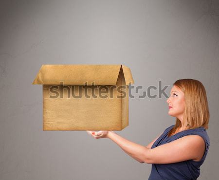 Young woman holding an empty cardboard box Stock photo © ra2studio