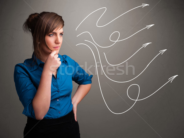 Attractive teenager looking at multiple curly arrows Stock photo © ra2studio