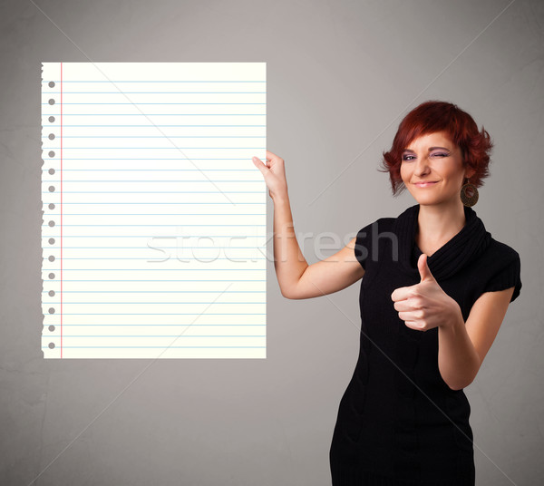 Stock photo: Young woman holding white paper copy space with diagonal lines