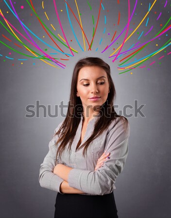 Young girl thinking with colorful abstract lines overhead Stock photo © ra2studio