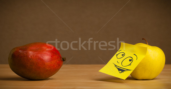 Apple with post-it note looking curiously at mango Stock photo © ra2studio
