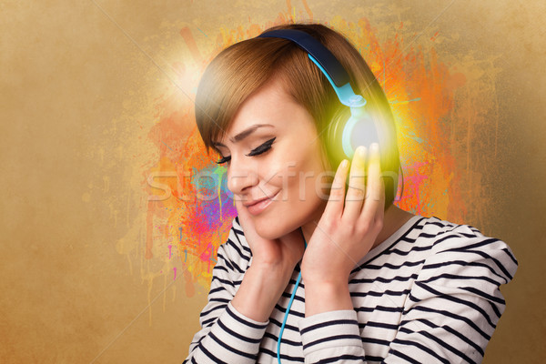 Young woman with headphones listening to music Stock photo © ra2studio