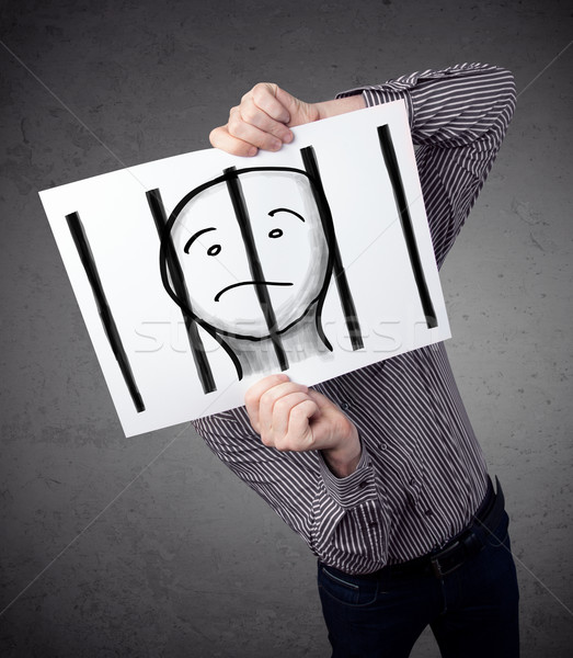 Businessman holding a paper with a prisoner behind the bars on i Stock photo © ra2studio