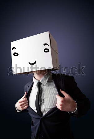Businessman gesturing with a cardboard box on his head with smil Stock photo © ra2studio