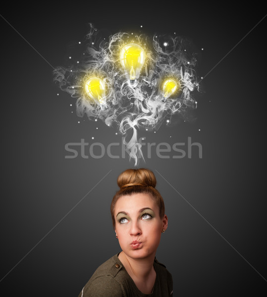 Stock photo: Thoughtful woman with smoke and lightbulbs above her head