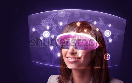 Pretty woman looking with futuristic high tech glasses  Stock photo © ra2studio