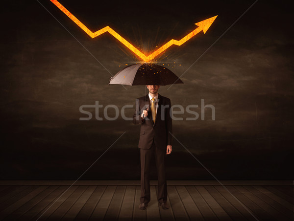 Businessman standing with umbrella keeping orange arrow  Stock photo © ra2studio