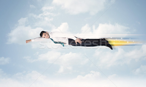 Happy business man flying fast on the sky between clouds Stock photo © ra2studio