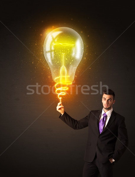 Businessman with an idea bulb Stock photo © ra2studio