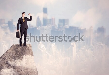 Winner urban businessman on top of stone  Stock photo © ra2studio