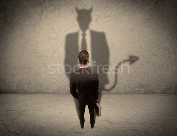 Salesman facing his own devil shadow Stock photo © ra2studio