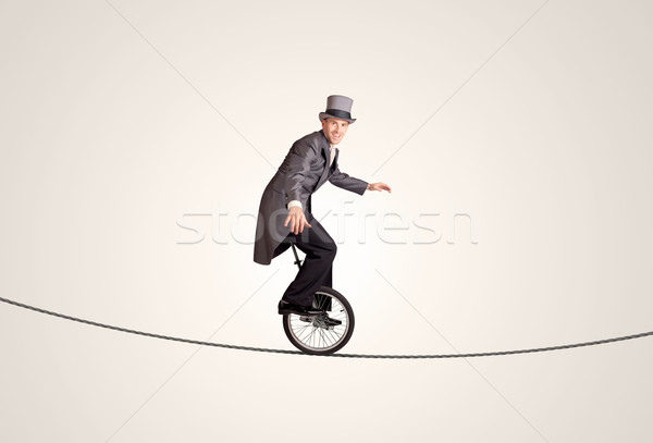 Ekstremalnych człowiek biznesu jazda konna monocyklu liny działalności Zdjęcia stock © ra2studio