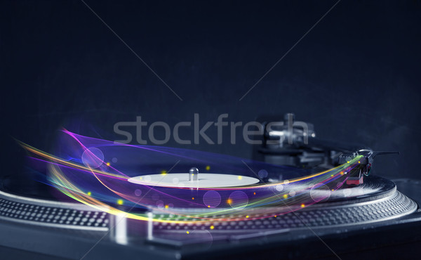 Stock photo: Turntable playing vinyl with glowing abstract lines