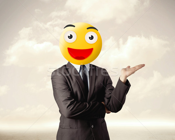 businessman wears yellow smiley face Stock photo © ra2studio