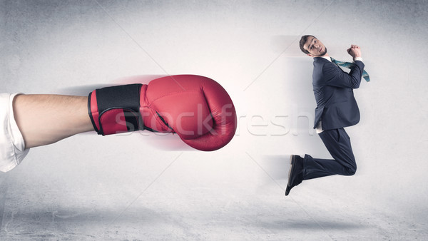 Businessman gets fired by a huge boxing hand Stock photo © ra2studio