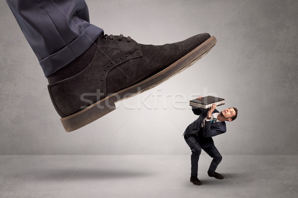Small man trampled by the great power Stock photo © ra2studio