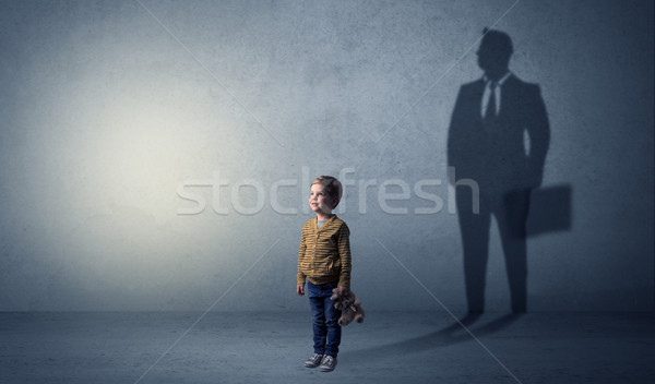 Little boy with businessman shadow Stock photo © ra2studio