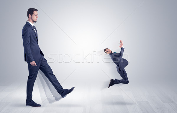 Giant businessman kicking out little businessman  Stock photo © ra2studio