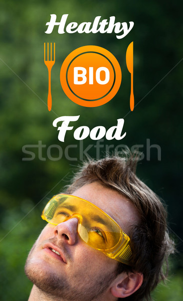 Young head looking at healthy food sign Stock photo © ra2studio