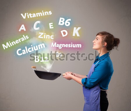 Young woman cooking vitamins and minerals Stock photo © ra2studio