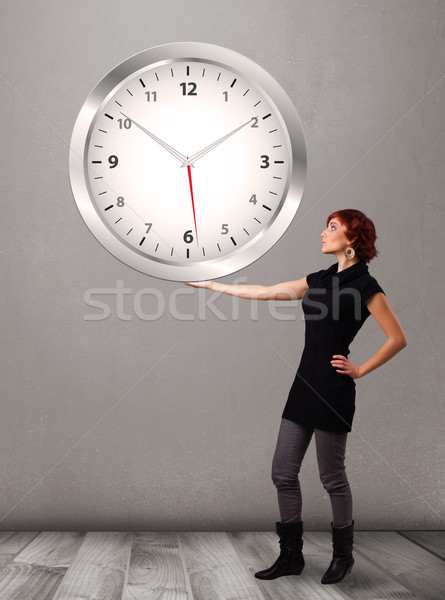 Stock photo: Attractive lady holding a huge clock