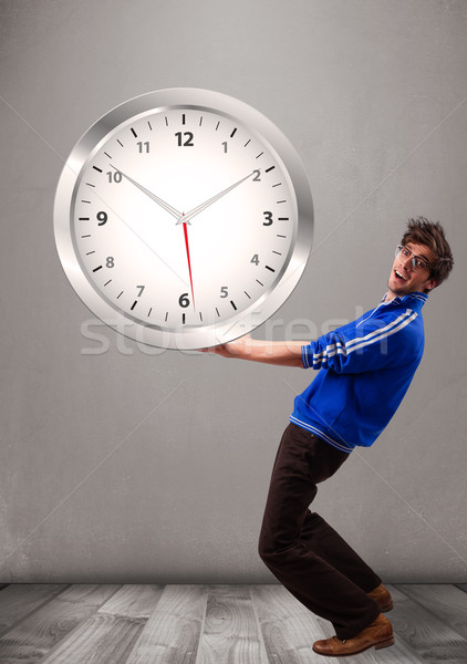 Attractive boy holding a huge clock Stock photo © ra2studio