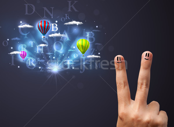 Happy cheerful smiley fingers looking at hot air balloons in the cloudy sky Stock photo © ra2studio