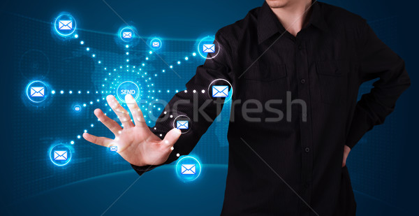 Businessman pressing virtual messaging type of icons Stock photo © ra2studio